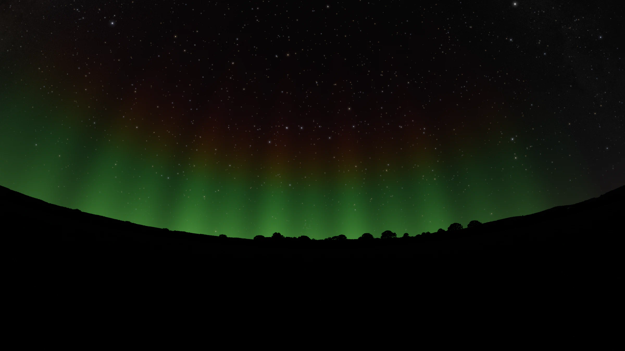 Green aurora with a faint red top glowing above a dark line of hills under a starry sky