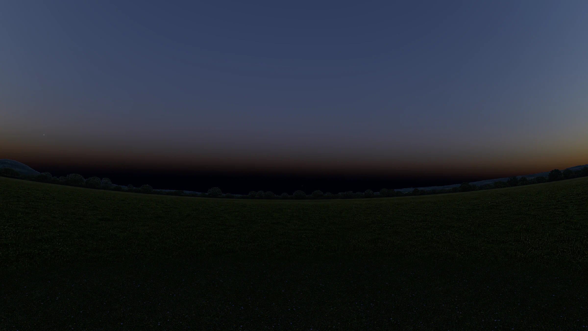A meadow at dusk facing east, a dark band of the Earth’s shadow along the horizon under a warm band of light and a blue sky