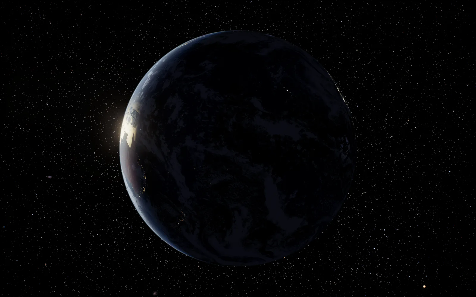 The night side, with sunrise breaking along the edge.