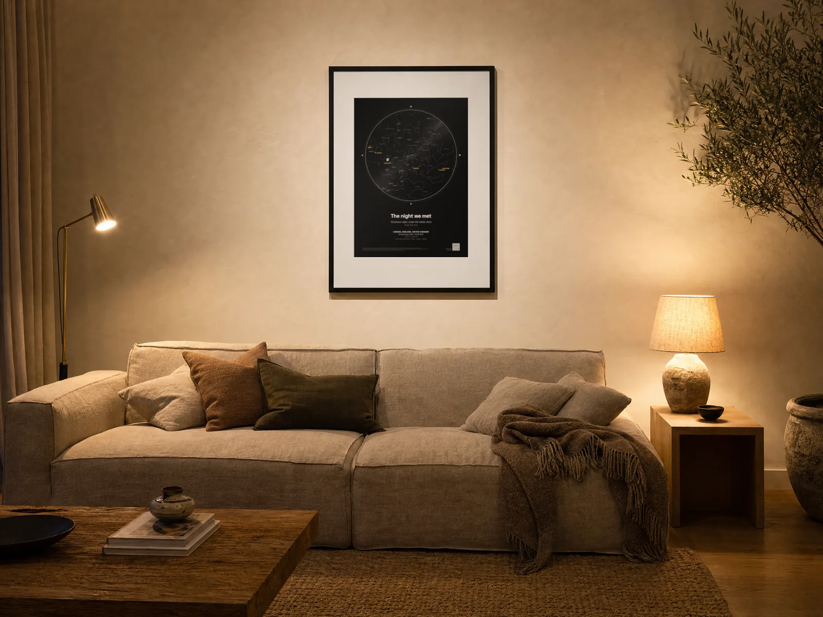 A framed star map print above a sofa in a living room