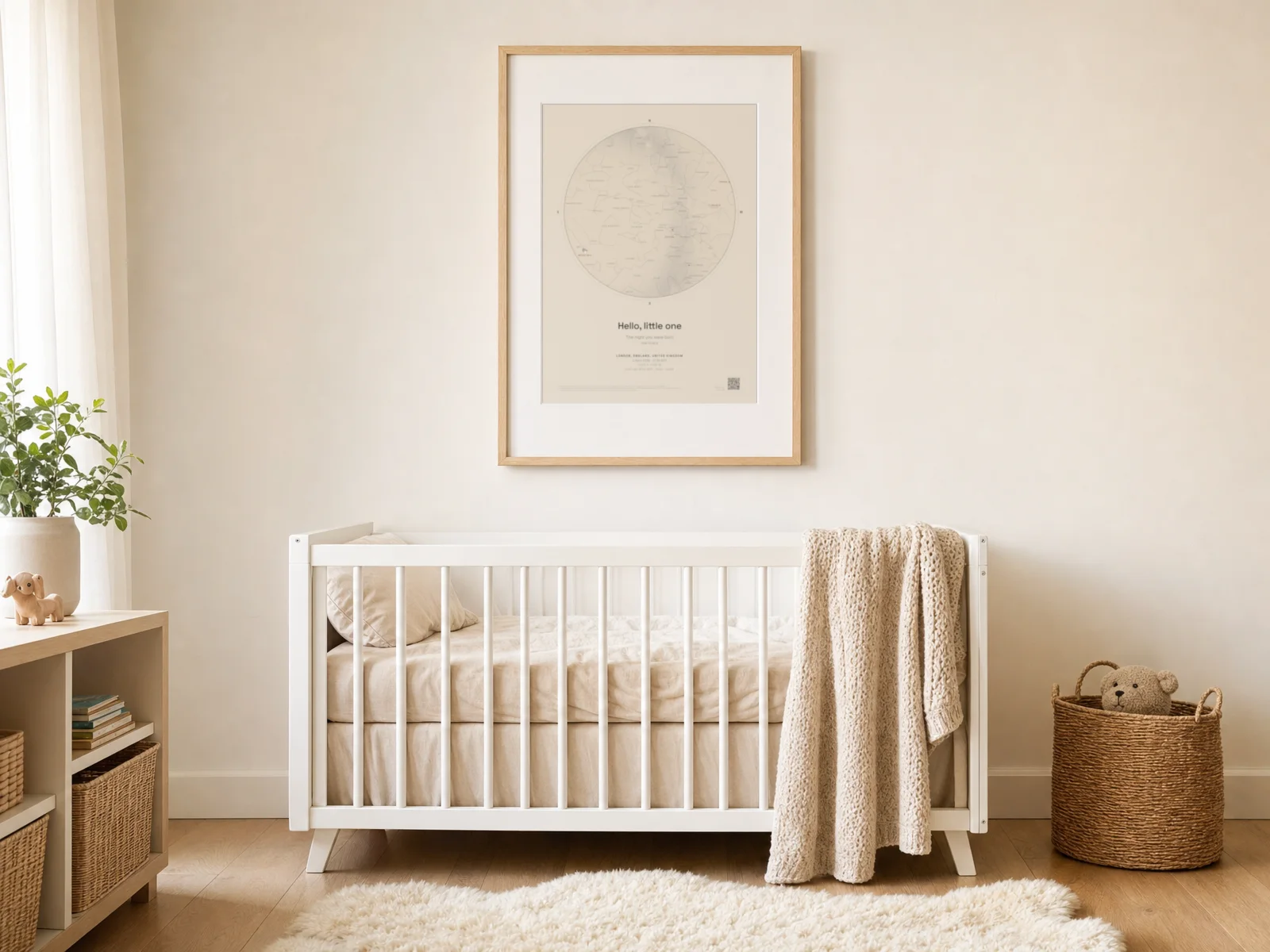 A cream star map print above a chest of drawers in a nursery