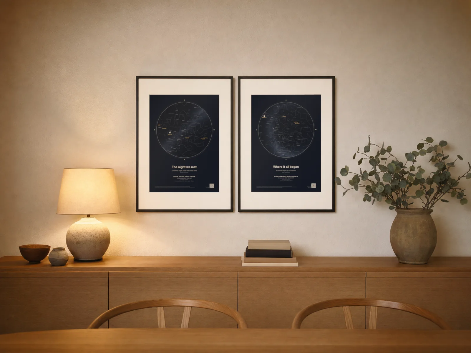 Two framed star map prints side by side above a sideboard